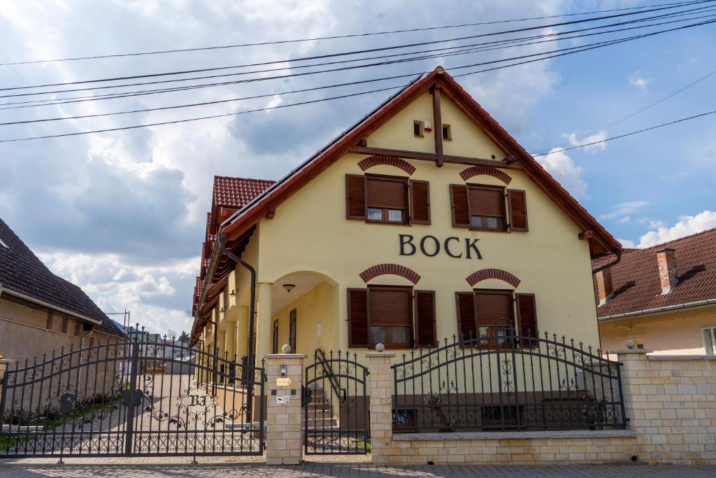 a building with a book written on the side of it at Private Vendégház in Villány