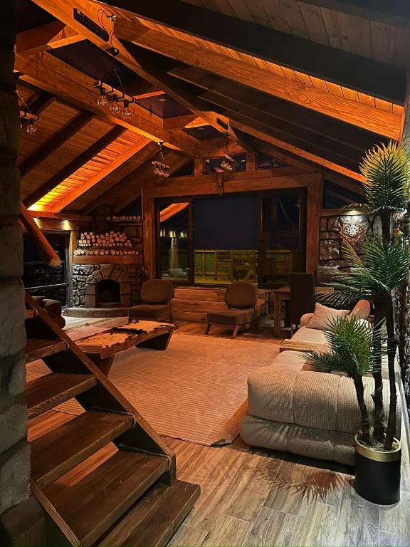 a large living room with a couch and a tv at Modatepe Bungalow & Otel in Uğurlu