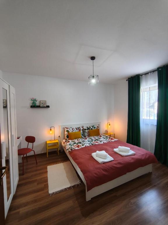 a bedroom with a large bed with a red blanket at Apartman Turkalj in Rakovica