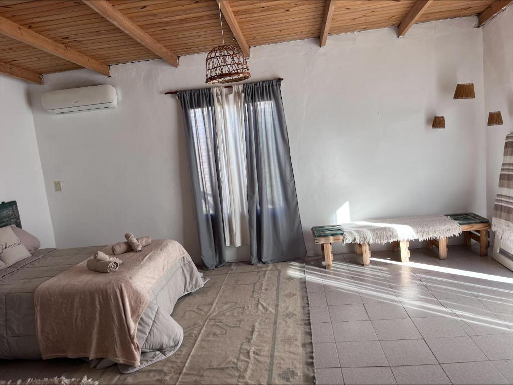 a bedroom with a bed and a large window at La martinez in San Antonio de Areco