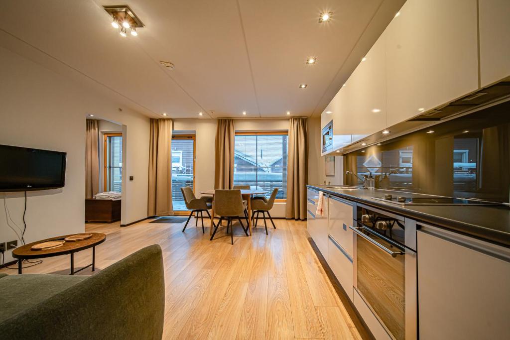 a kitchen and living room with a table and chairs at City Centre Apartment Levi in Sirkka