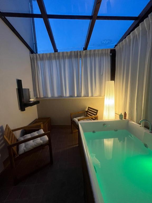 a room with a bath tub and a room with a tv at Suite con jacuzzi in pieno centro in Benevento