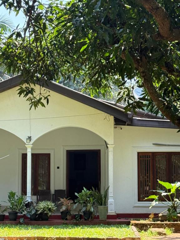a white house with plants in front of it at Niwasa Habarana in Habarana