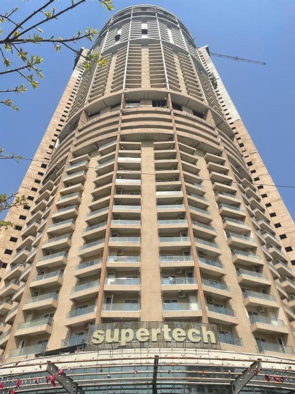 a tall building with a sign on the side of it at Aayu's Home 74 in Noida