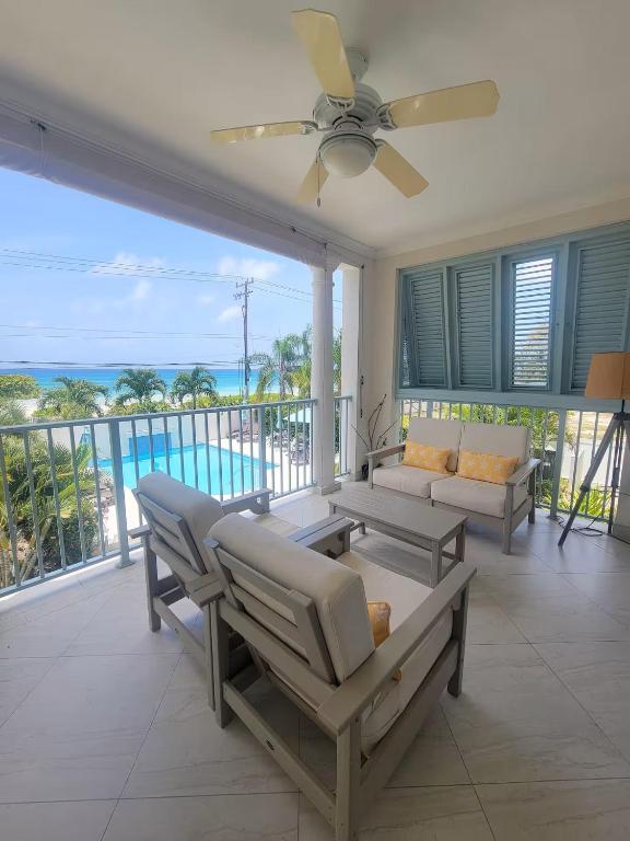 a living room with a view of the ocean at 102 Lighthouse Bay Barbados in Christ Church