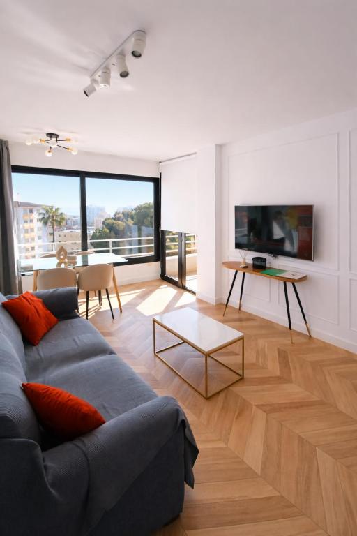 a living room with a couch and a table at panoramic boutique con preciosas vistas in Benalmádena