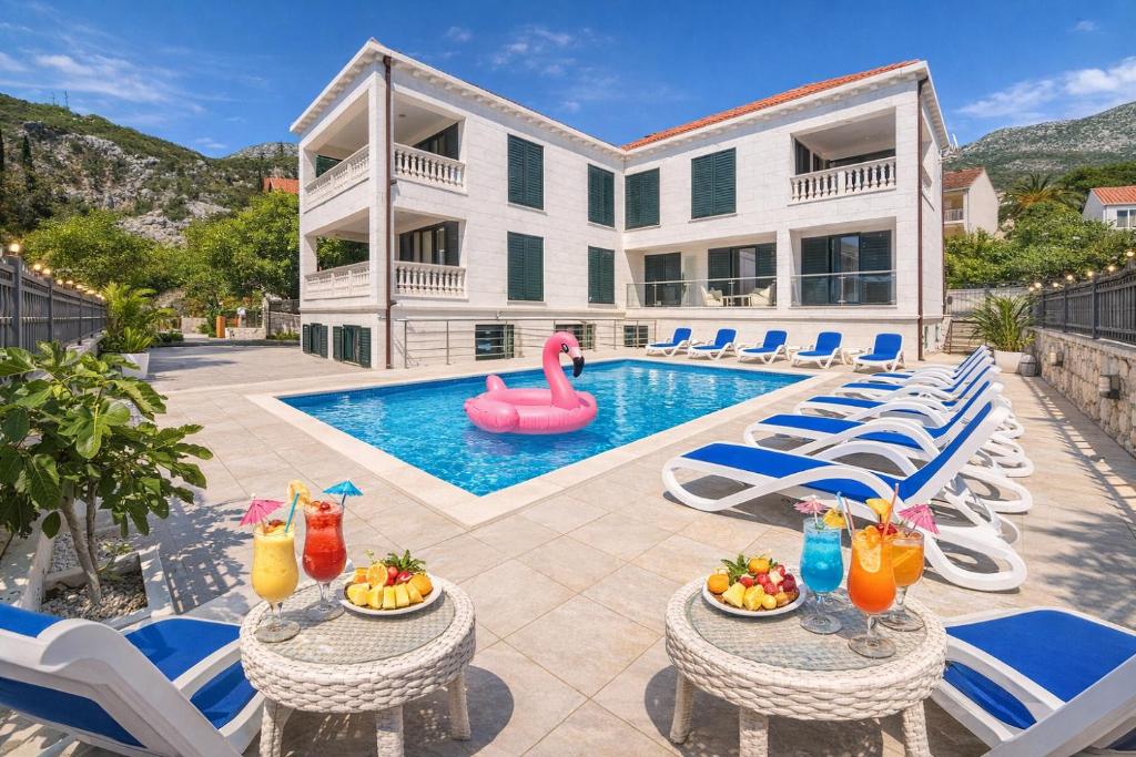 a villa with a swimming pool and a pink swan at Villa Slano in Slano