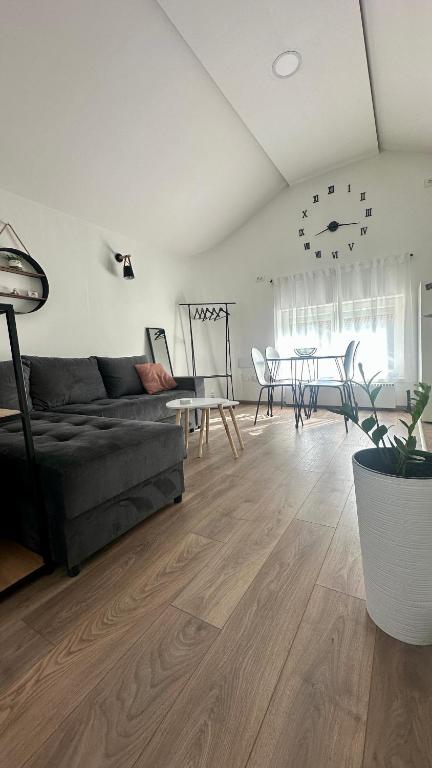 a living room with a couch and a table at Lane Stay Studio in Beograd
