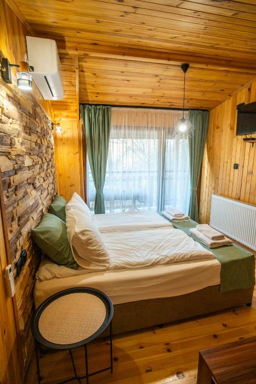 a large bed in a room with a window at Green View 2 in Skrino