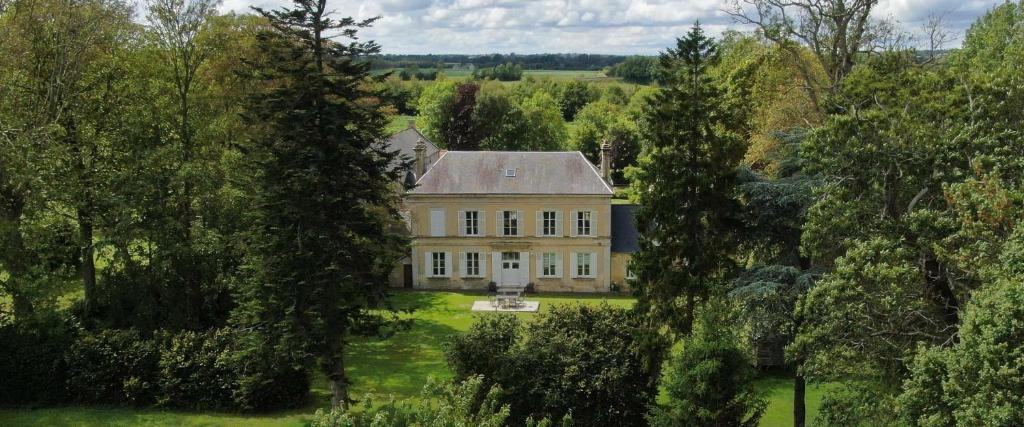 an aerial view of a large house with trees at La Fresnée chambres d'hôtes in Mosles
