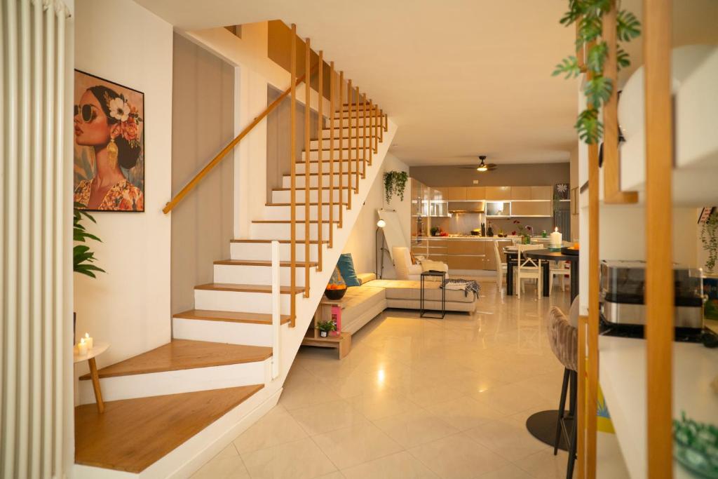 a staircase in a house with a living room at Corte Cavour Duplex Gallarate centro, Wifi e Garage in Gallarate