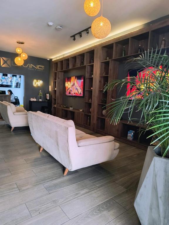 a living room with a couch and a tv at Xliving Host and Rooms in Bogotá