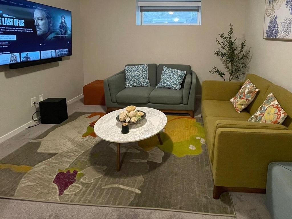 a living room with a couch and a table at Mary's Luxury Suite in Winnipeg