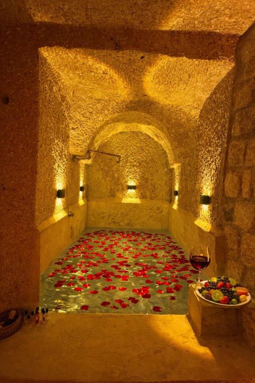 a room with a bunch of red flowers on the floor at Masal Cave Suites - Where Story Begins in Ürgüp