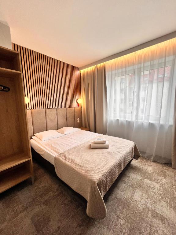 a bedroom with a bed and a window at Baltic Hotel in Gdynia