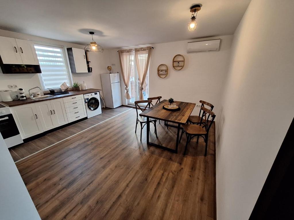 a kitchen and dining room with a table and chairs at Апартамент Бохо 2 in Primorsko