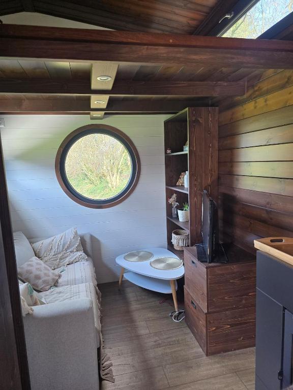 a living room with a couch and a window at La Perle des Sentiers in Rhisnes