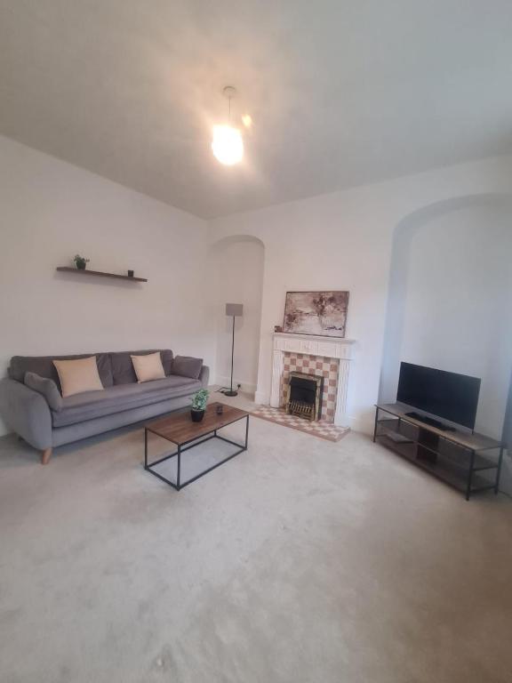a living room with a couch and a fireplace at Blyth 1 Bedroom Apartment in Blythe