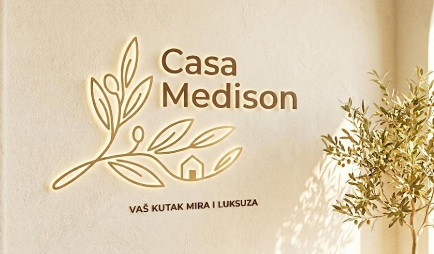 a sign for a casa melision sign on a wall at Casa & Spa Medison in Zrenjanin
