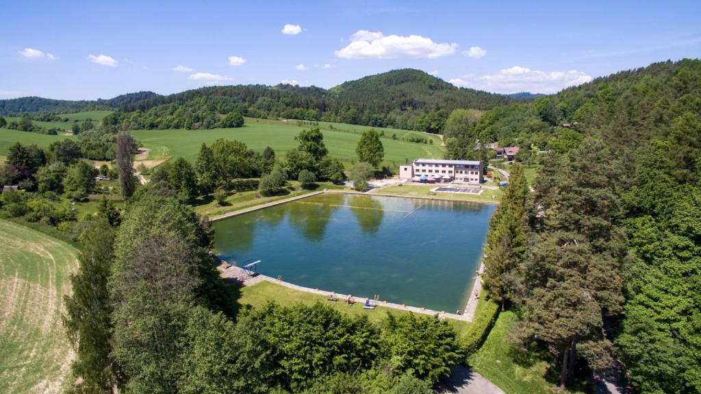 an aerial view of a lake in the mountains at Vlčí důl Bludov in Bludov