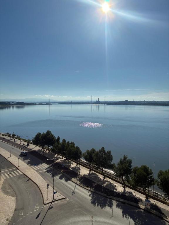 a view of a large body of water with a bridge at Vieira's House in Barreiro