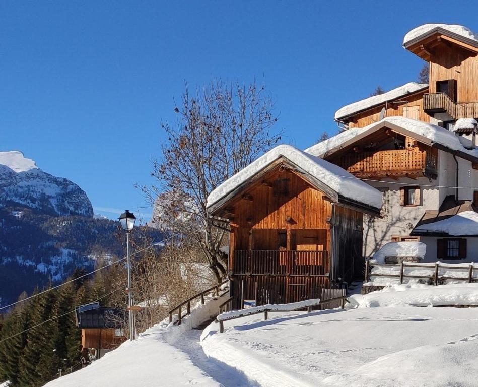 a ski lodge in the mountains in the snow at The Little Cottage in Alleghe