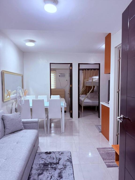 a living room with a couch and a table with chairs at Vernes Homestay in Mandaue City