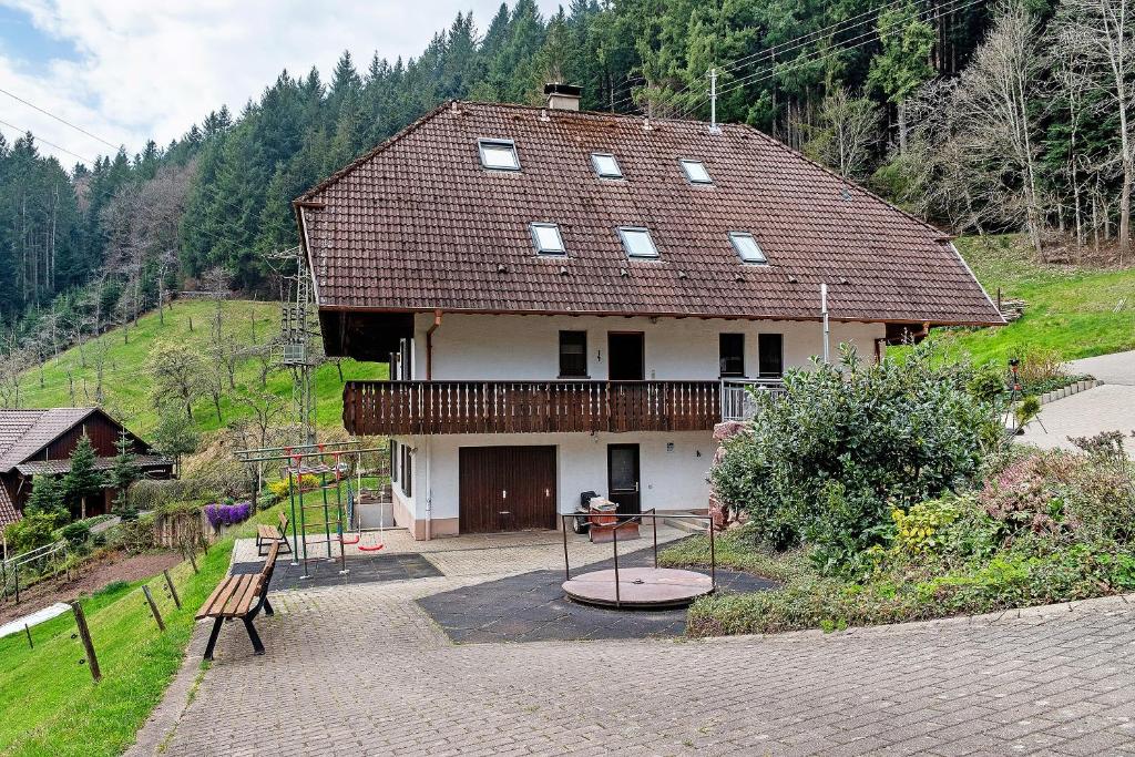 a small house with a playground in front of it at Bergbauernhof 1910 in Oberharmersbach