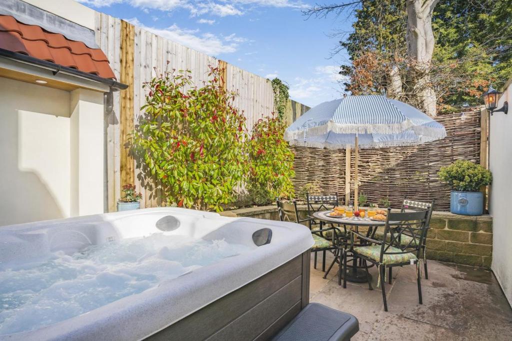 a hot tub in a backyard with a table and chairs at 2 Bed in Helmsley oc-p36613 in Helmsley