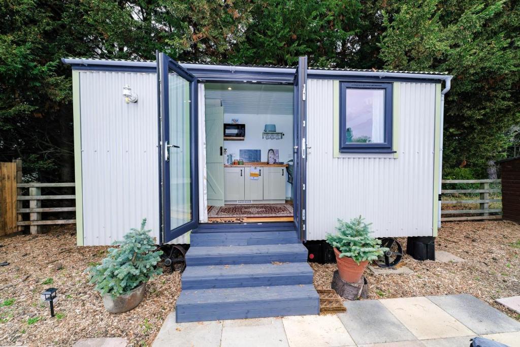 a small shed with a staircase leading to the door at 1 Bed in Raunds oc-s33685 in Raunds
