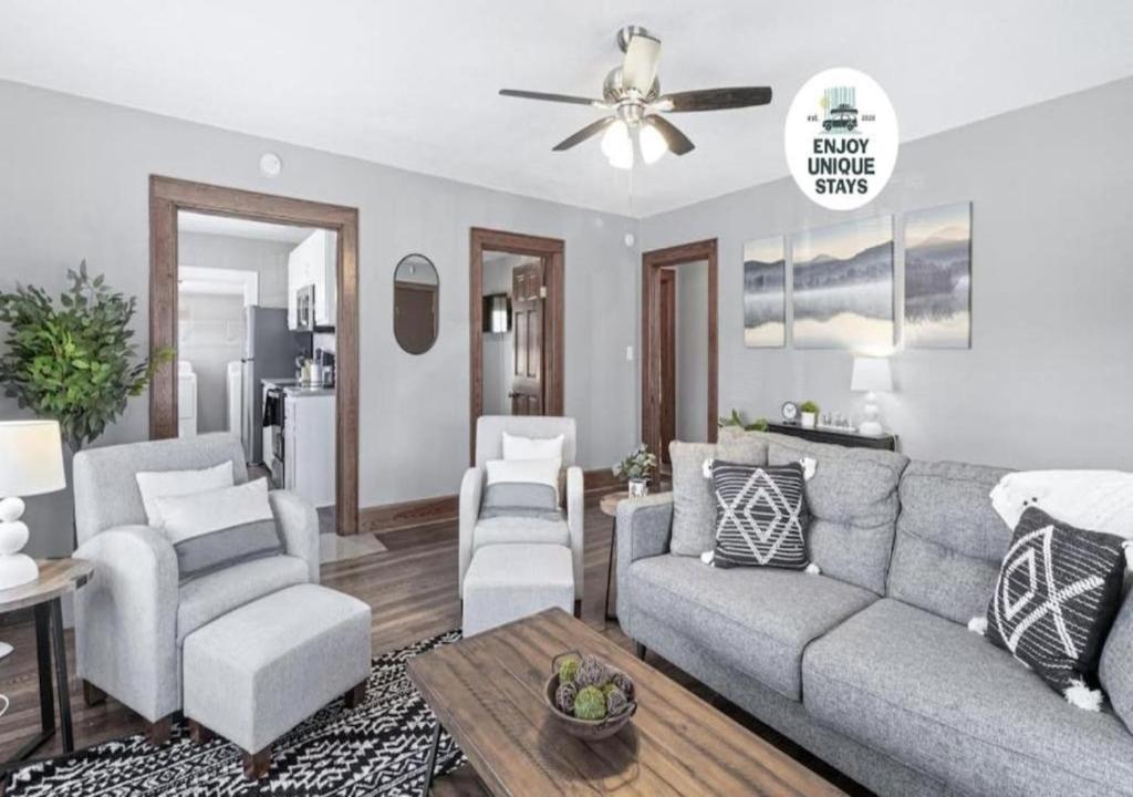 a living room with a couch and chairs and a ceiling fan at Red Bud in Chattanooga
