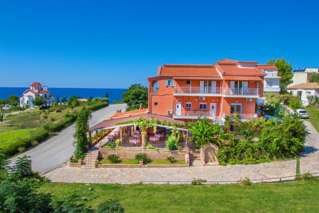 an aerial view of a house with the ocean in the background at Studios Konstantina in Ligia