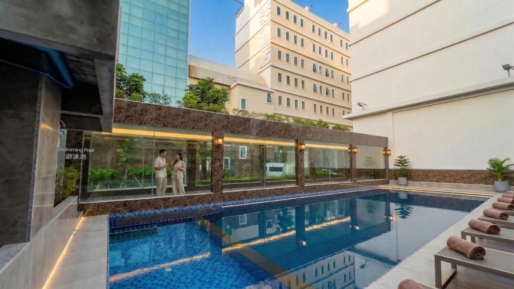 a swimming pool in the middle of a building at Elegant Airport Hotel in Bangkok