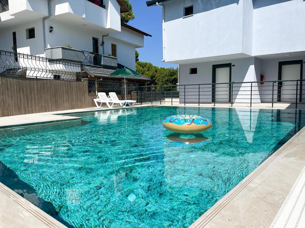 a swimming pool with a boat in the middle of a house at MY Sunset Suite in Kuşadası