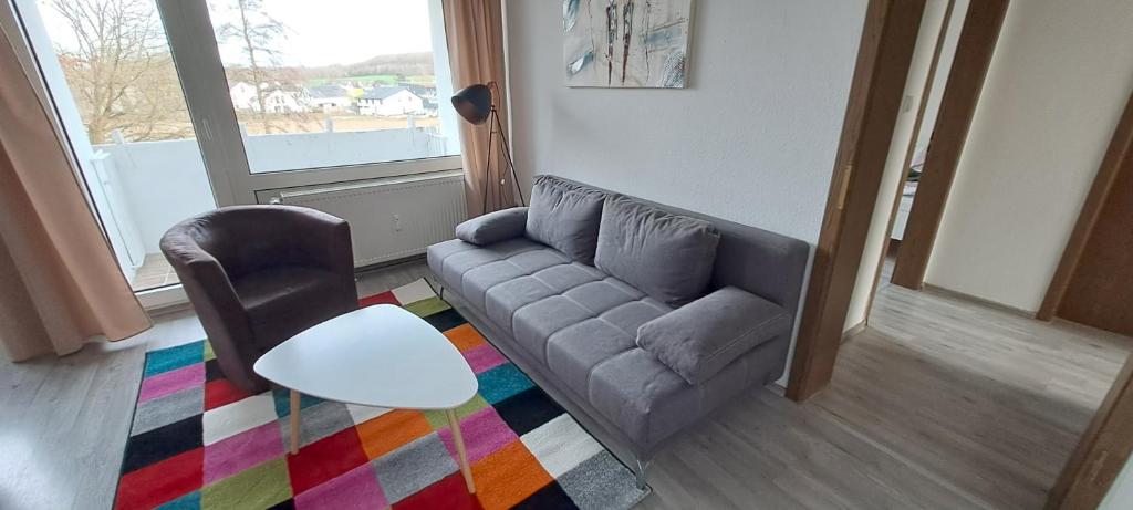 a living room with a couch and a chair at 40L 3OG r in Castrop-Rauxel