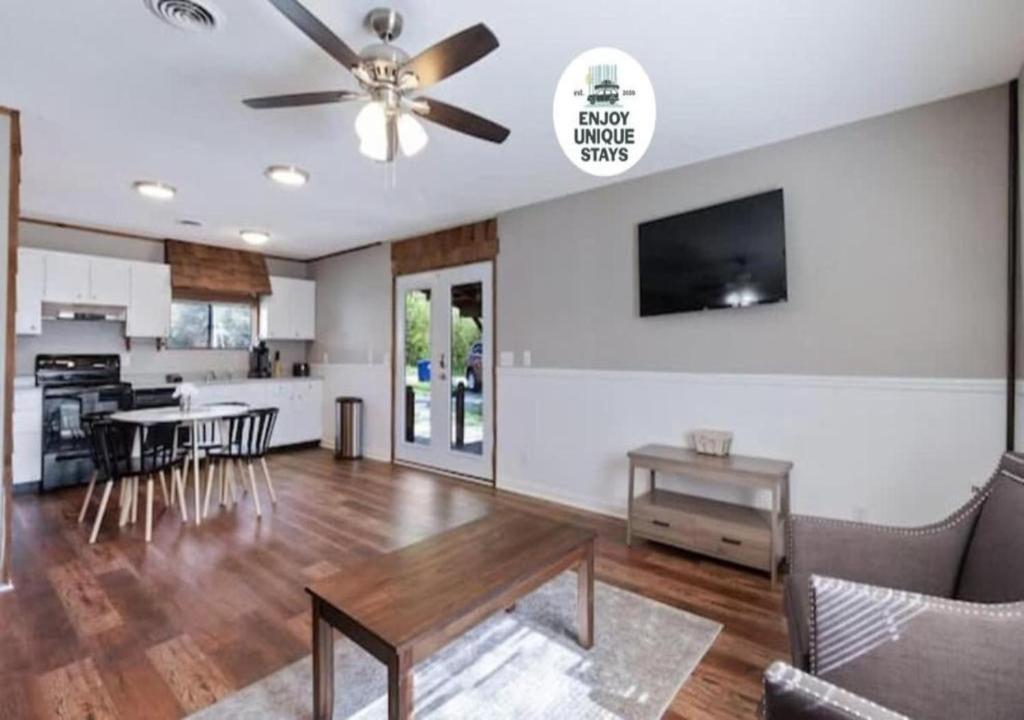 a living room with a ceiling fan and a table at Pawnee Duplex in Chattanooga Unit 1 in Chattanooga