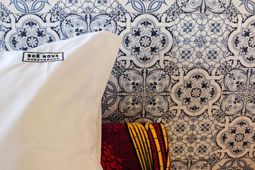 a white shirt and a wall with a wallpaper at BN GHouse in Lisbon