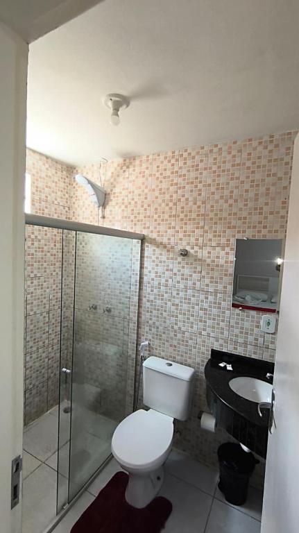 a bathroom with a toilet and a shower and a sink at Hotel Senna in Arapiraca