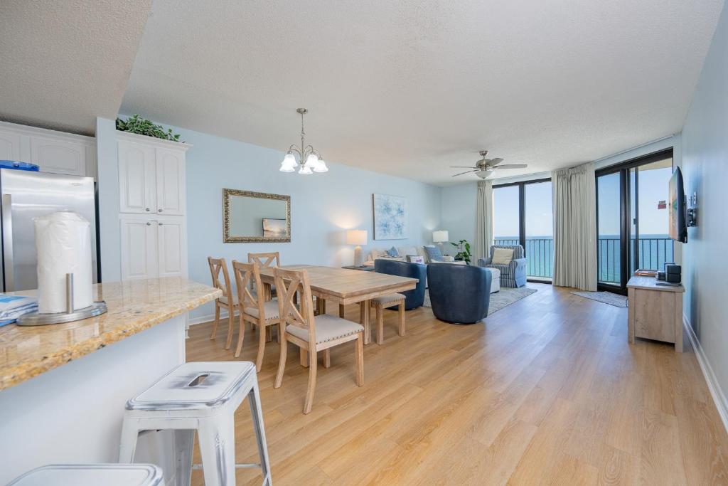 a kitchen and living room with a table and chairs at Phoenix X 1110 in Orange Beach