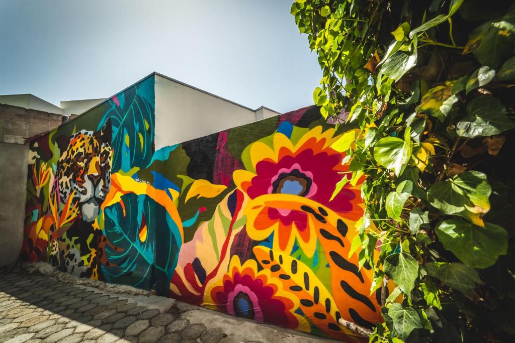 a wall with a painting of a chicken on it at Stylish Apartment Upscale Chapultepec District in Tijuana