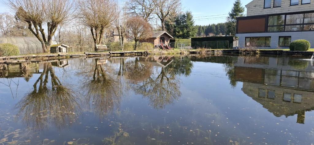 a large body of water next to a building at Bulle d'eau in Gouvy