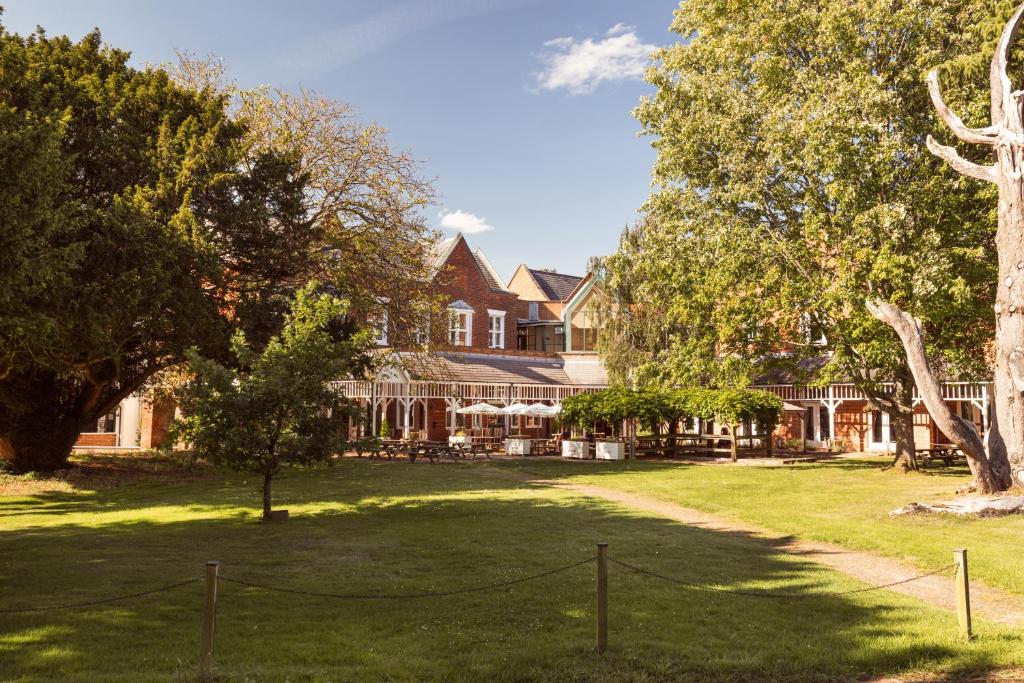 a large house with a yard in front of it at Coulsdon Manor Hotel and Golf Club in Croydon