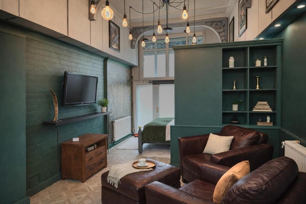a living room with a couch and a tv at Arena Apartment Meadowhall in Brightside