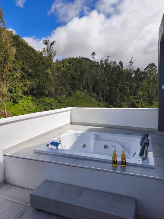 a jacuzzi tub on a balcony with a view at Mirador samsara Jacuzzi al aire libre 60 m2 in La Calera