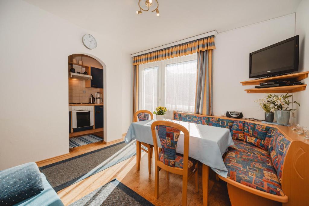 a living room with a table and a couch at Unterwötzlhof in Abtenau