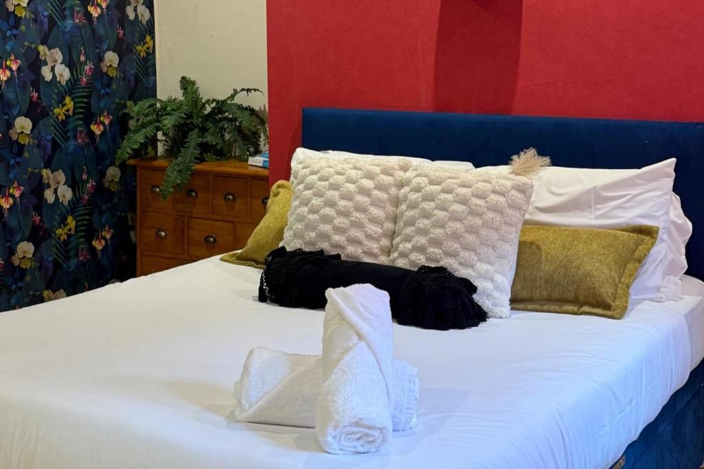 a white bed with a blue headboard and pillows at 1 Bed Flat - Sleeps 5 - Pet friendly - Parking in South Shields