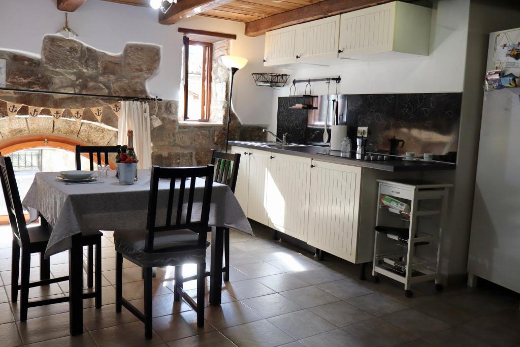 a kitchen with a table and chairs in a kitchen at Casa Margherita in Bolsena
