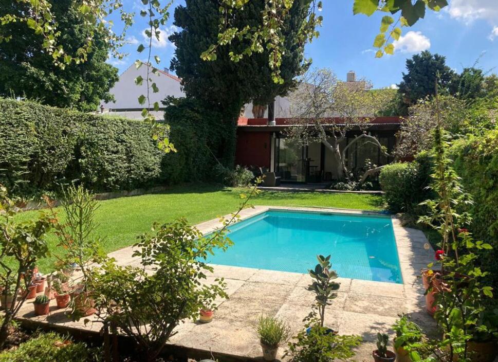 a swimming pool in the yard of a house at Florida Private loft, shared garden pool in Florida
