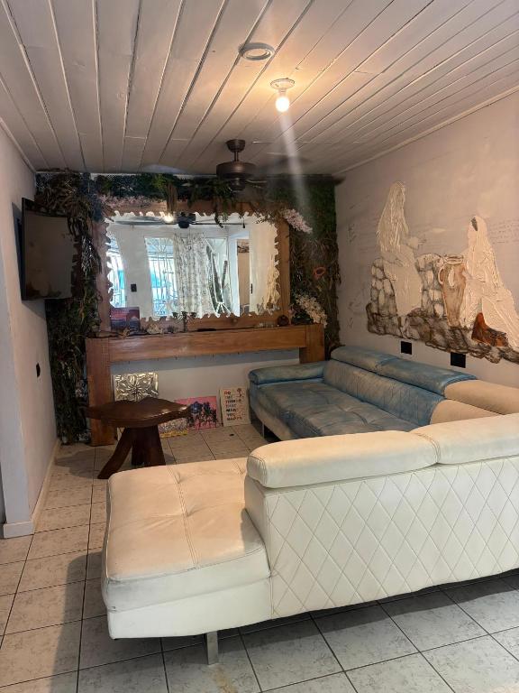 a room with a bed and a couch and a table at Hilltop Candy in San Isidro de El General