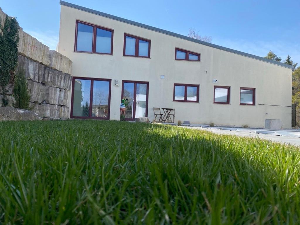 a large building with windows and a grass field at Ferienwohnung Red Horse Ranch in Eichstätt